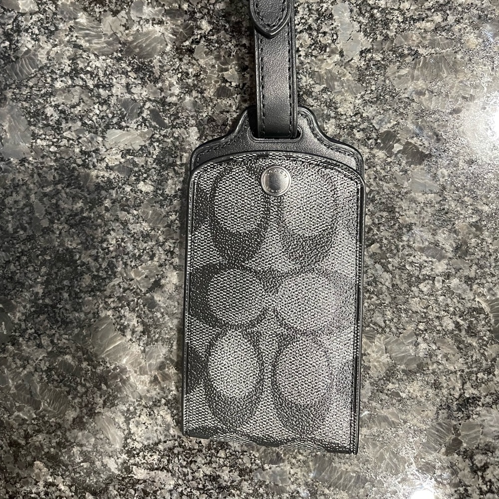 Coach luggage tag. Never used. Mint condition. Smoke free and pet free home.